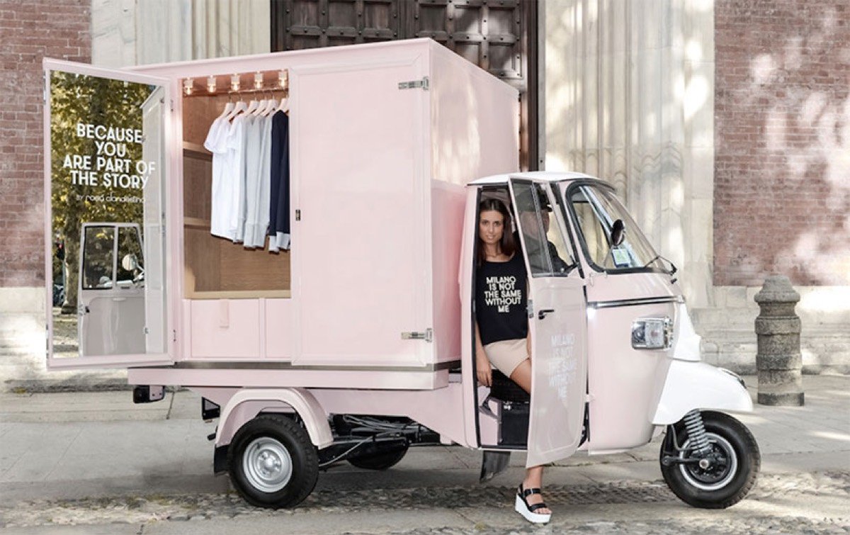 A converted three-wheeled vehicle used as a mobile fashion boutique.