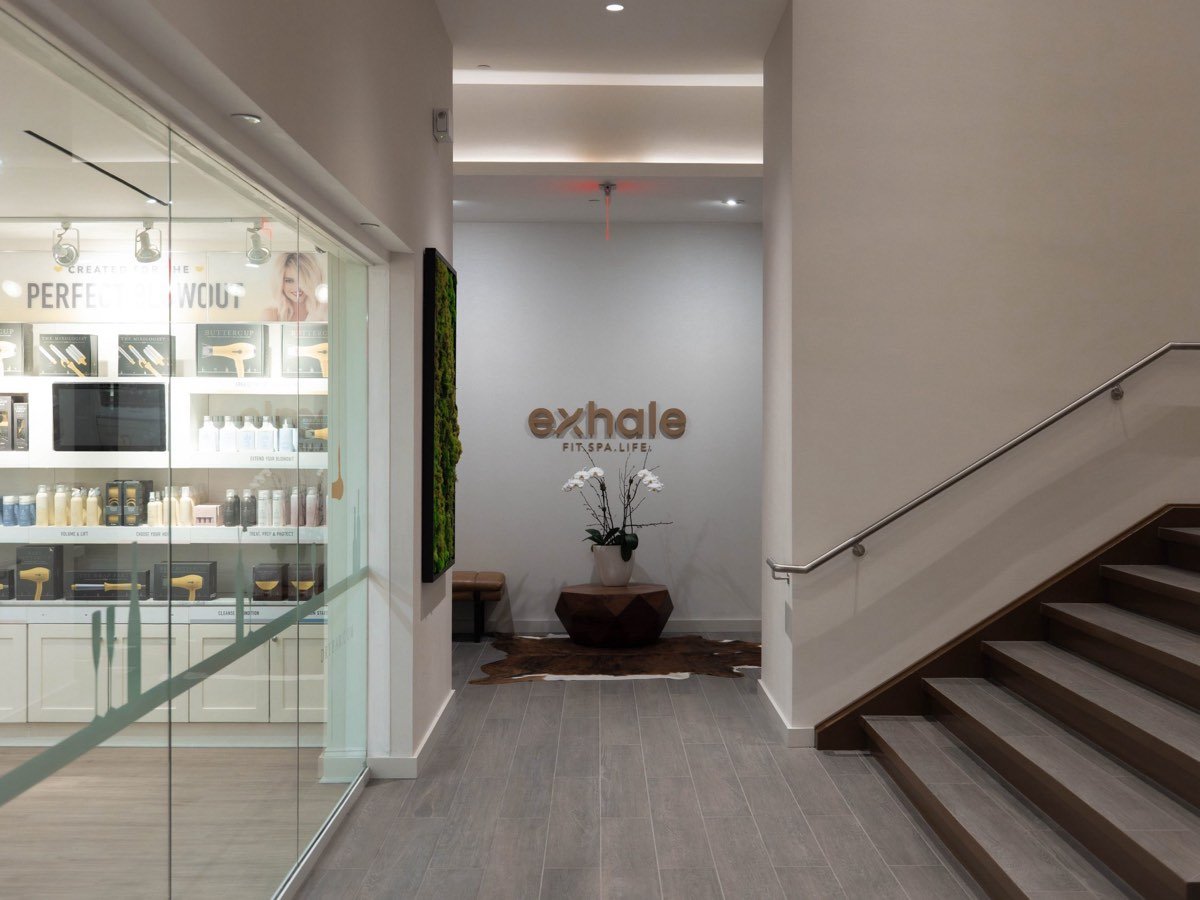The Drybar retail display beside the reception area of an Exhale spa.